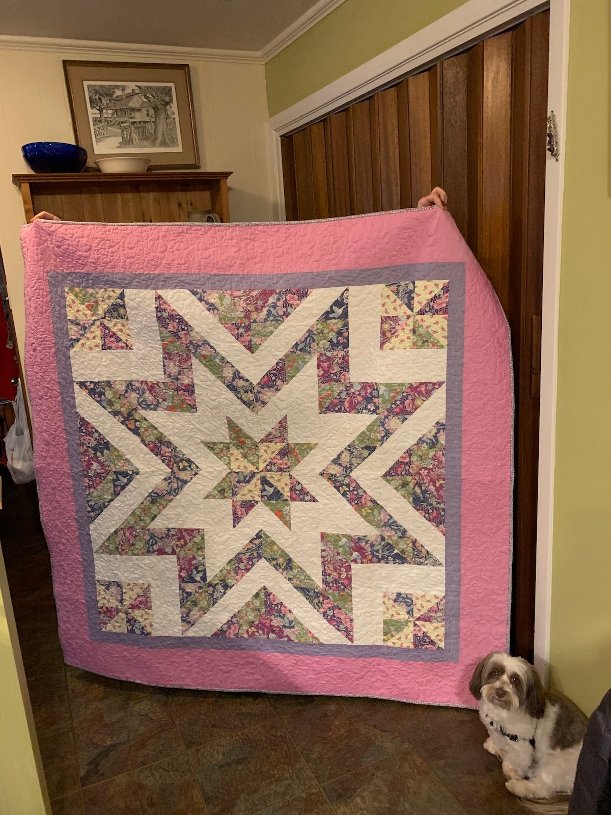 Student with their finished Guiding Star quilt
