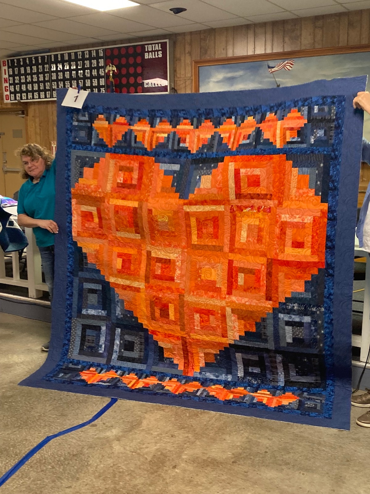 Student Paulette with her finished I Heart Log Cabin quilt