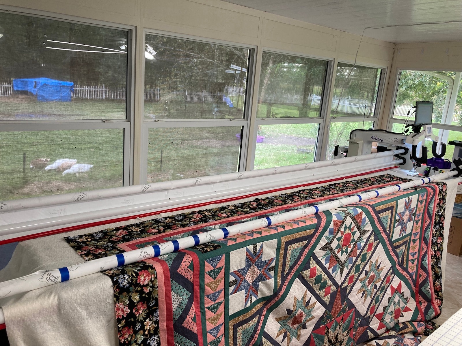 Quilt top loaded using the floating method on the long arm frame