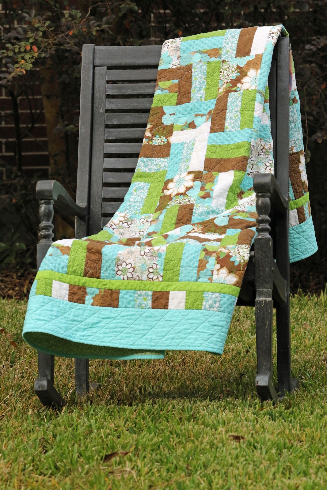 Wildflower quilt draped over a garden rocking chair